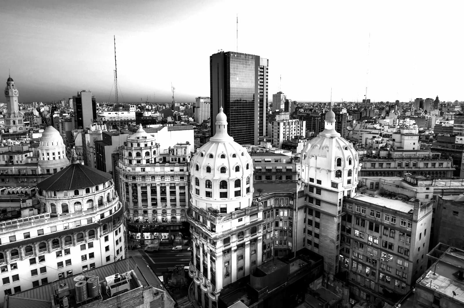 Cityscape of Buenos Aires featuring historic domed buildings and a modern skyline.