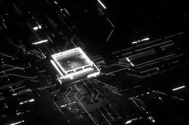 Glowing central microchip illuminating surrounding circuit pathways in a dark, high‑contrast environment.