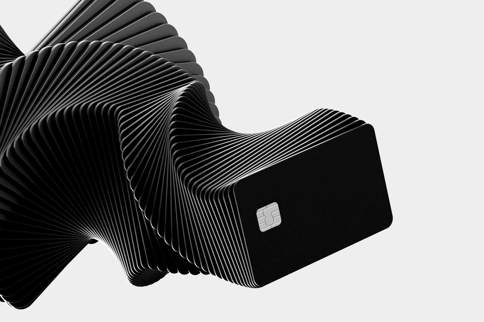 Stacked credit cards forming a twisted, spiral-like shape, with one card showing a visible chip