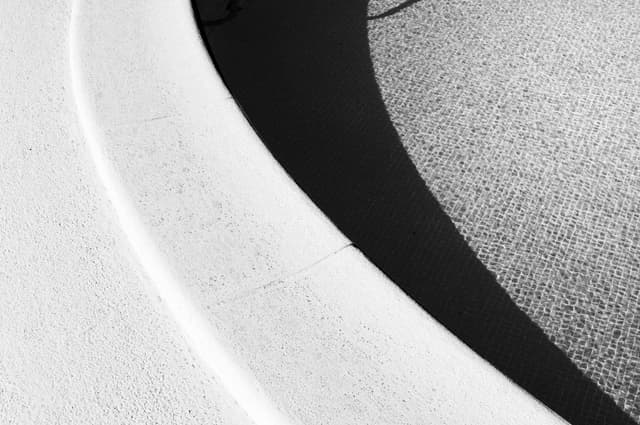 edge of an empty shallow swimming pool with steps