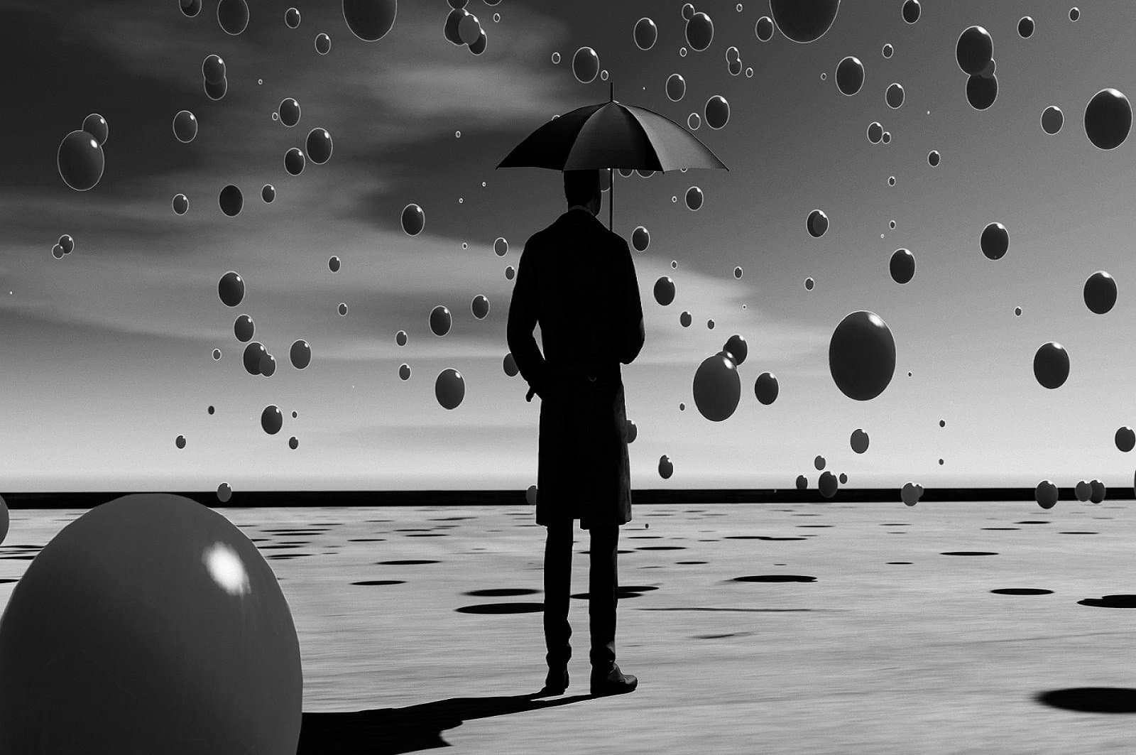 Balls fall from the sky while man with umbrella