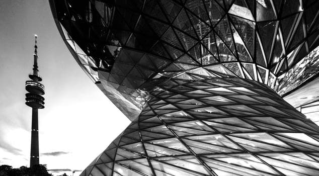 Close up of Modern architecture with the olympic tower of munich in the background