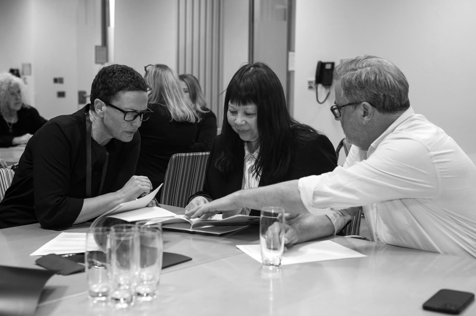 A group of business individuals sitting around a table 
