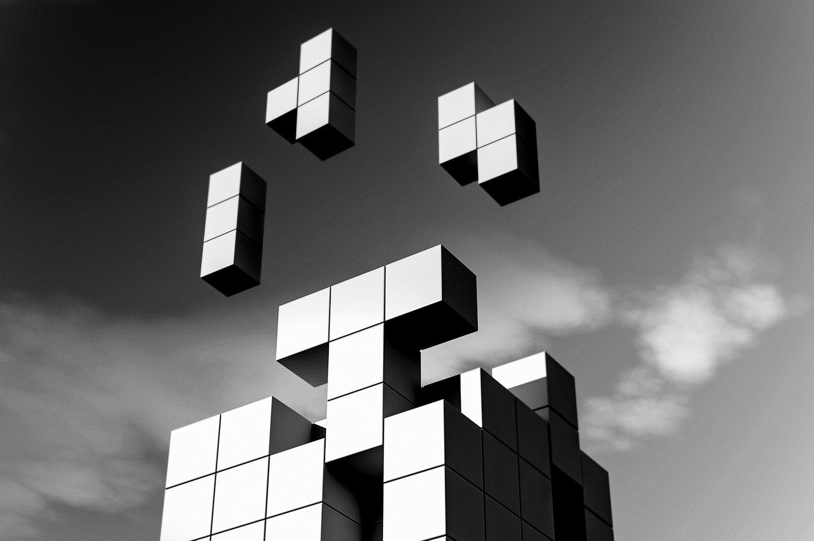 tower of blocks with random boxes coming off into the sky
