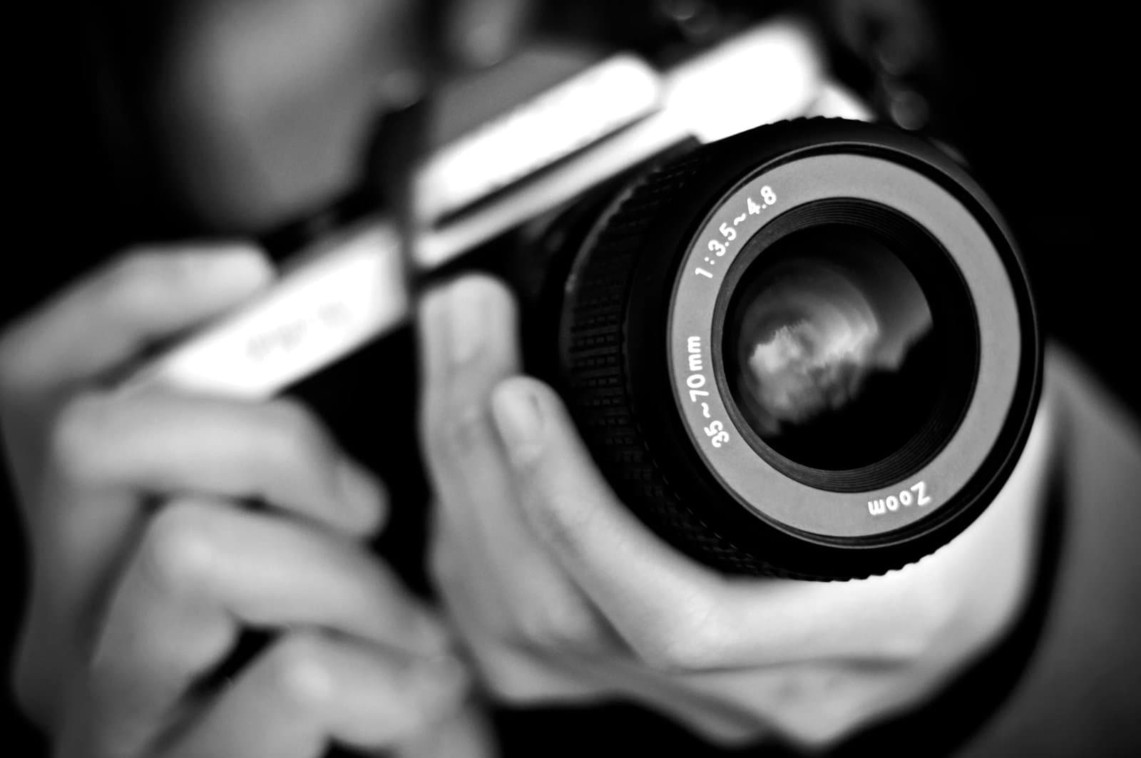 A girl holding an old film camera